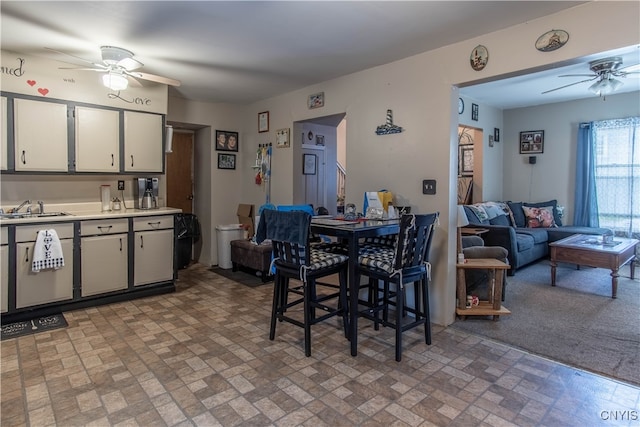 kitchen with sink, white cabinets, and ceiling fan