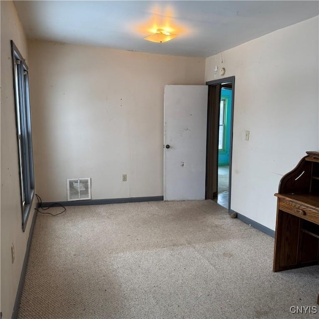 spare room featuring light colored carpet