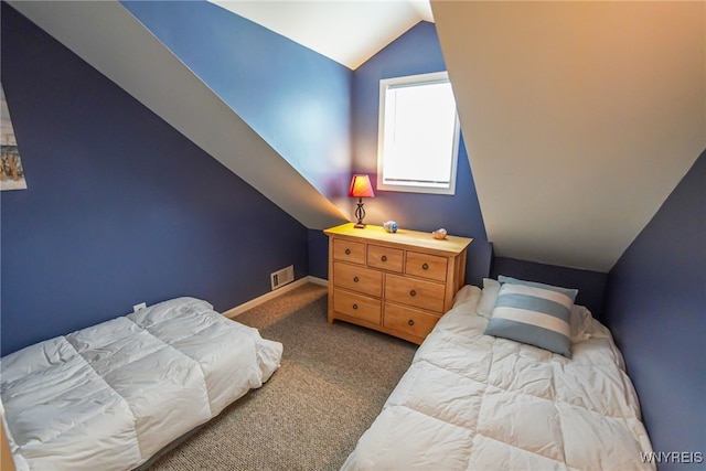 carpeted bedroom with lofted ceiling