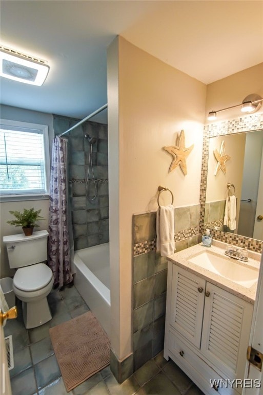 full bathroom with shower / bath combo, tile patterned flooring, vanity, and toilet