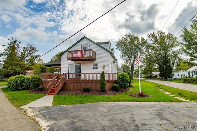 view of front of house with a front yard and a deck