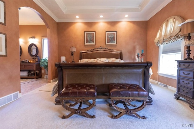 bedroom featuring light colored carpet, a raised ceiling, and ornamental molding