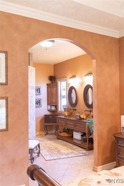 bathroom with tile patterned floors, crown molding, and vanity