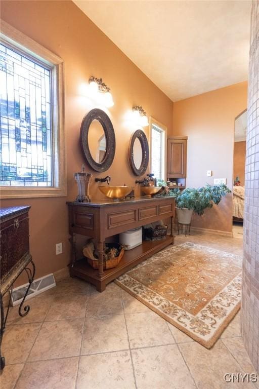 bathroom featuring tile patterned flooring and vanity