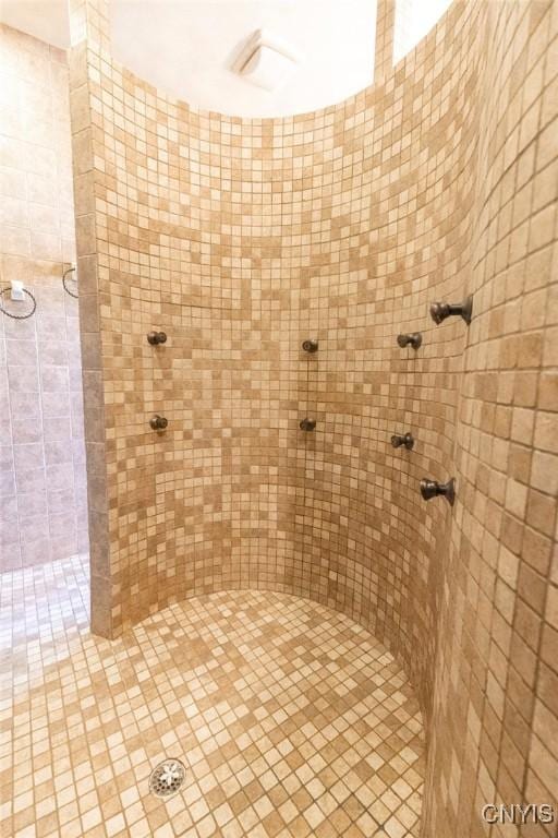 bathroom with tiled shower