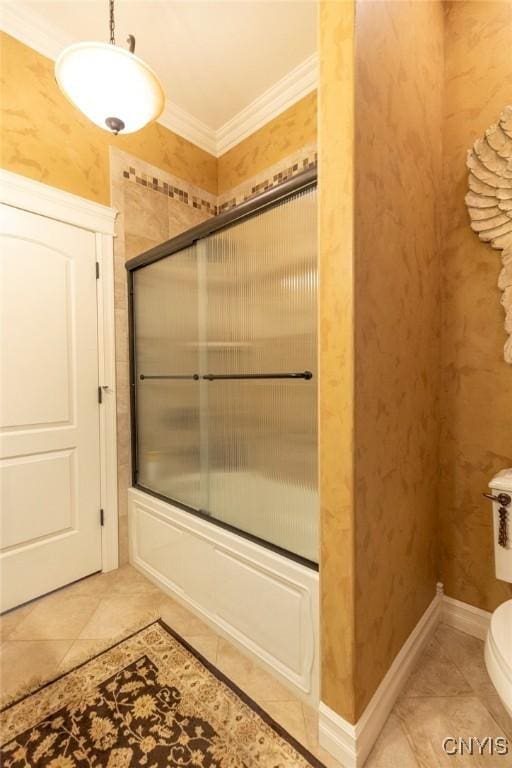 bathroom featuring tile patterned flooring, toilet, combined bath / shower with glass door, and crown molding