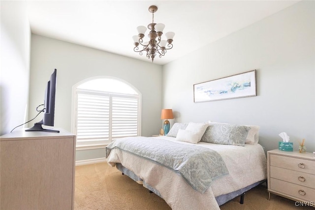 bedroom featuring a notable chandelier and light colored carpet