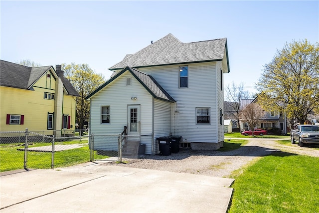 back of property featuring a yard