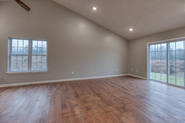 spare room with ceiling fan, light hardwood / wood-style flooring, and high vaulted ceiling