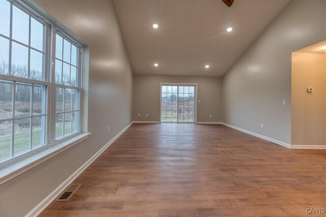 unfurnished room featuring light hardwood / wood-style floors and high vaulted ceiling