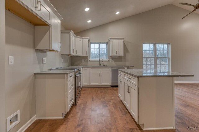 kitchen featuring ceiling fan, white cabinets, stainless steel appliances, and light hardwood / wood-style flooring