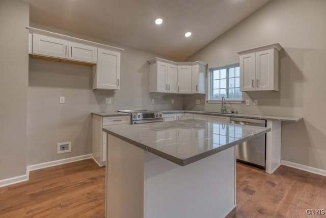 8195 Rachel Ct, Clay, NY 13027 - kitchen featuring vaulted ceiling, light wood-style flooring, appliances with stainless steel finishes, white cabinetry, and a sink