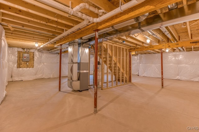 basement with water heater and heating unit