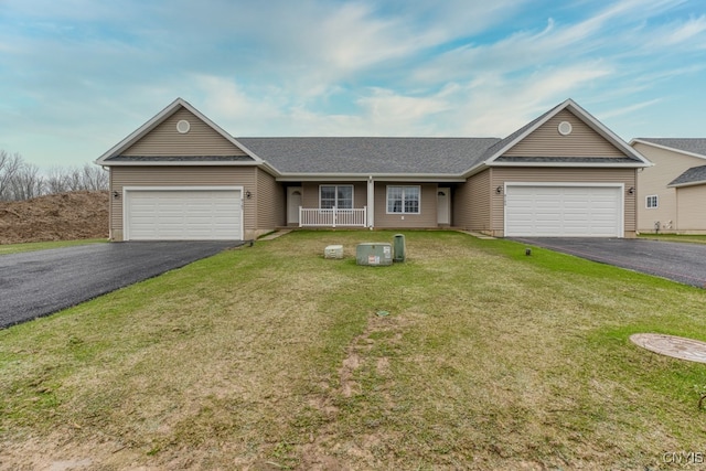 ranch-style home featuring a garage and a front lawn