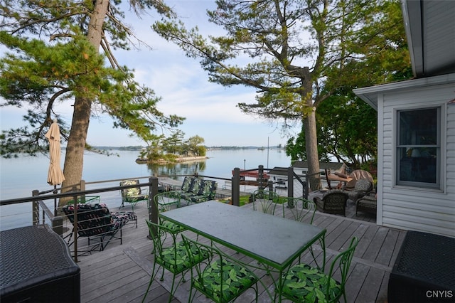 wooden terrace featuring a water view