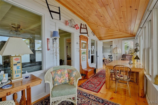 sunroom / solarium with ceiling fan, vaulted ceiling, and wooden ceiling