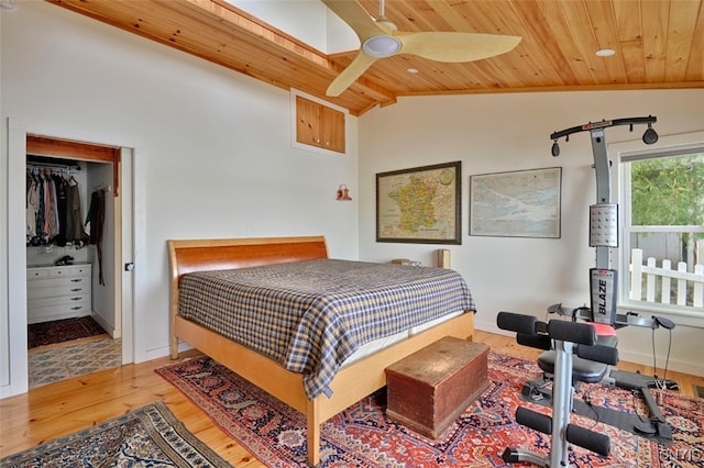 bedroom with vaulted ceiling, a closet, wooden ceiling, ceiling fan, and hardwood / wood-style flooring