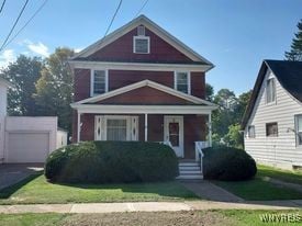 view of front facade with a garage and covered porch