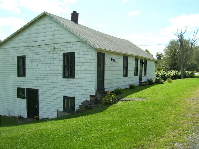 back of property with a lawn