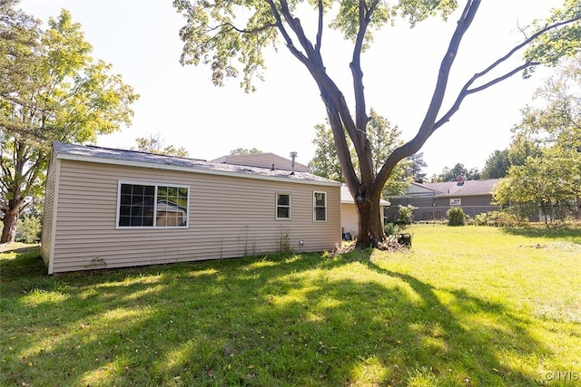 back of house with a lawn