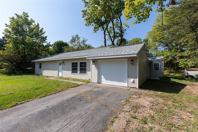 view of front of property featuring a garage and a front lawn