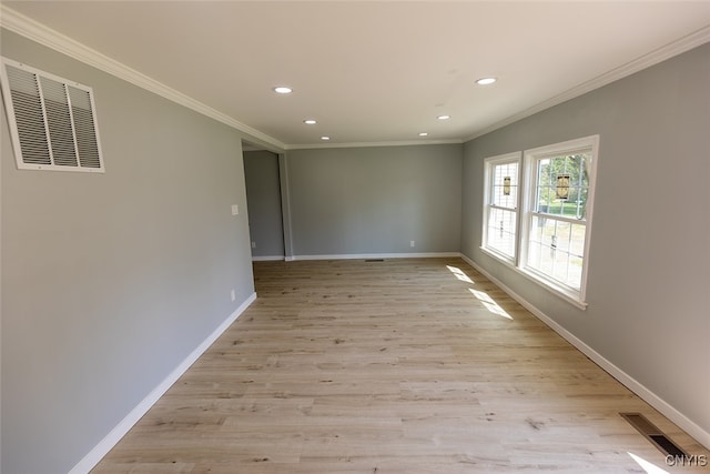 unfurnished room with crown molding and light hardwood / wood-style flooring