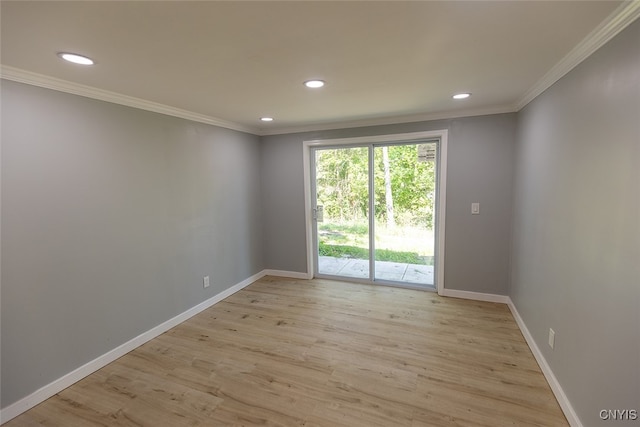 unfurnished room featuring light hardwood / wood-style flooring and crown molding