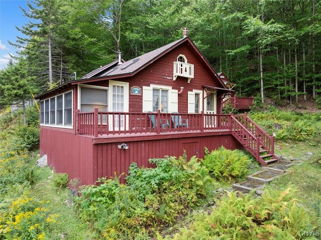 rear view of house with a wooden deck