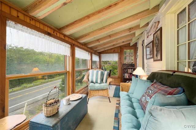 sunroom / solarium featuring lofted ceiling with beams