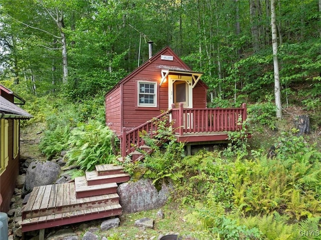 3544 State Route 28, Webb, NY 13420 - rear view of property with a forest view, a deck, stairs, and an outdoor structure
