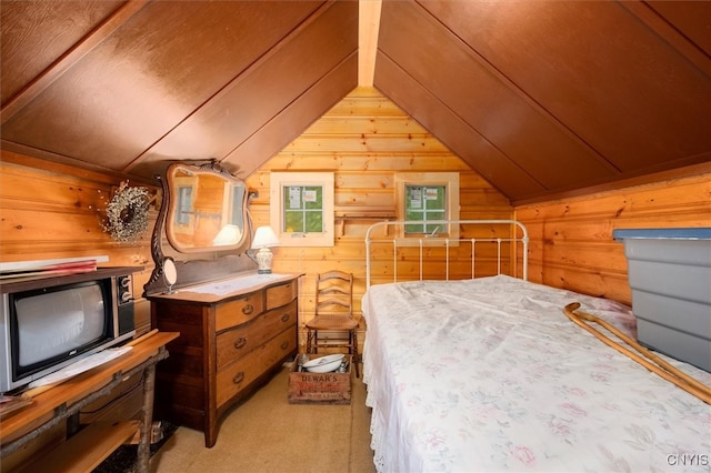 unfurnished bedroom with wooden walls, vaulted ceiling, and light carpet