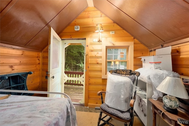 bedroom featuring carpet flooring, wood walls, and vaulted ceiling