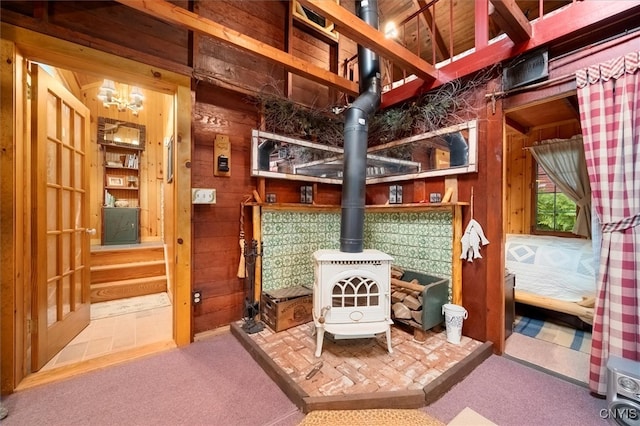 interior space with wood walls and a wood stove