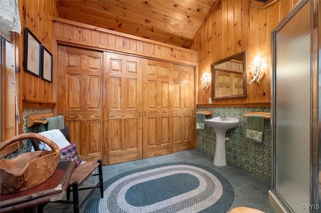 bathroom with tasteful backsplash, wooden ceiling, lofted ceiling, tile patterned flooring, and a shower with door