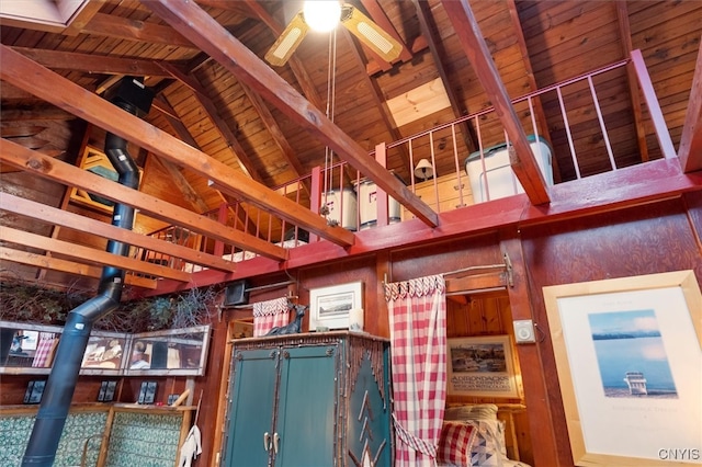 interior space featuring ceiling fan, beamed ceiling, and wooden ceiling