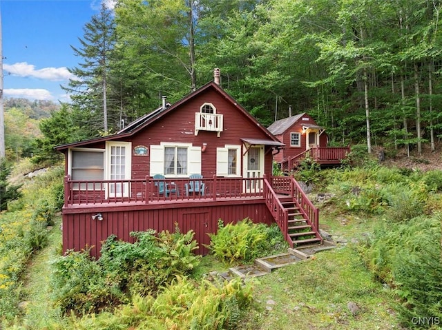 3544 State Route 28, Webb, NY 13420 - view of front of property featuring a wooden deck, stairway, and a wooded view