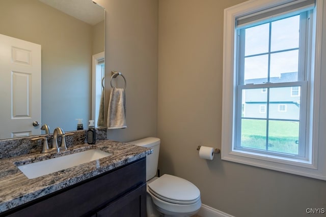 bathroom featuring vanity and toilet