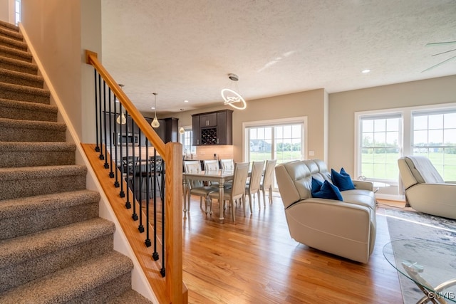 living room featuring a textured ceiling and light hardwood / wood-style floors