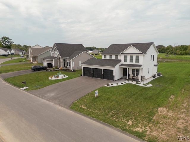 view of front of property featuring a garage and a front lawn