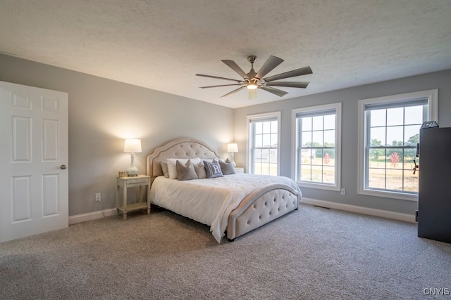 bedroom featuring carpet, ceiling fan, and a textured ceiling