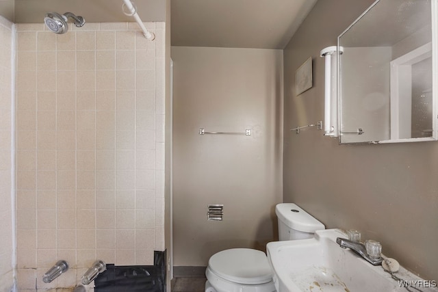 bathroom with toilet, walk in shower, and sink