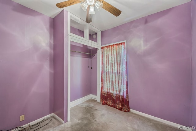 unfurnished bedroom featuring ceiling fan, light colored carpet, and a closet