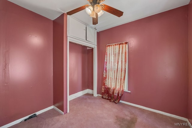 unfurnished bedroom with ceiling fan and light colored carpet