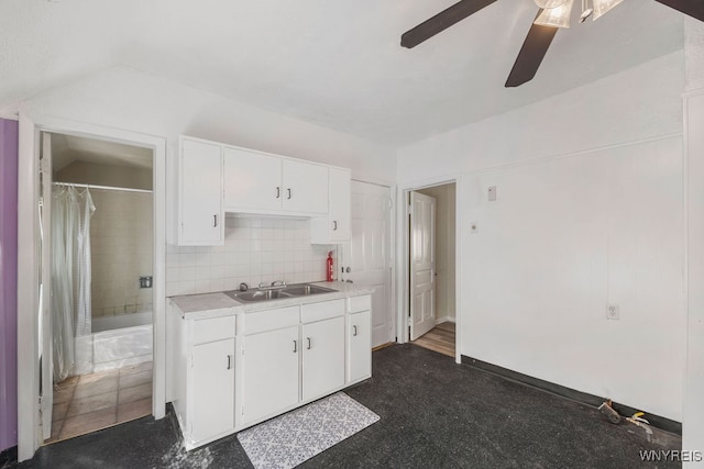 kitchen featuring white cabinets, tasteful backsplash, ceiling fan, and sink