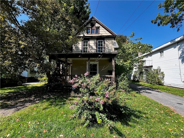 view of front of house featuring a porch and a front lawn