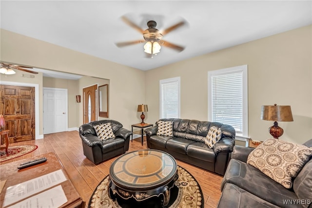 living room with light hardwood / wood-style floors and ceiling fan