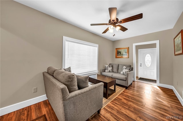 living room with ceiling fan and hardwood / wood-style flooring