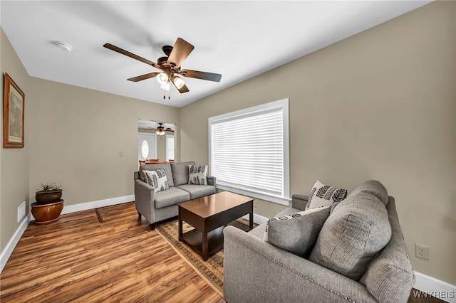 living room featuring wood-type flooring and ceiling fan