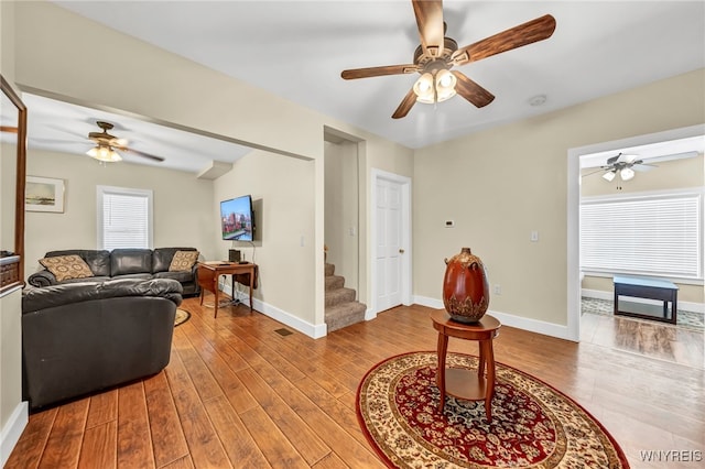 living room featuring light wood-type flooring and ceiling fan