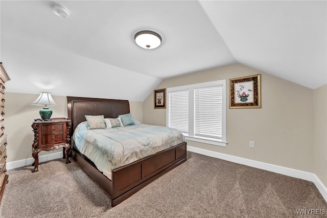 bedroom with carpet floors and vaulted ceiling